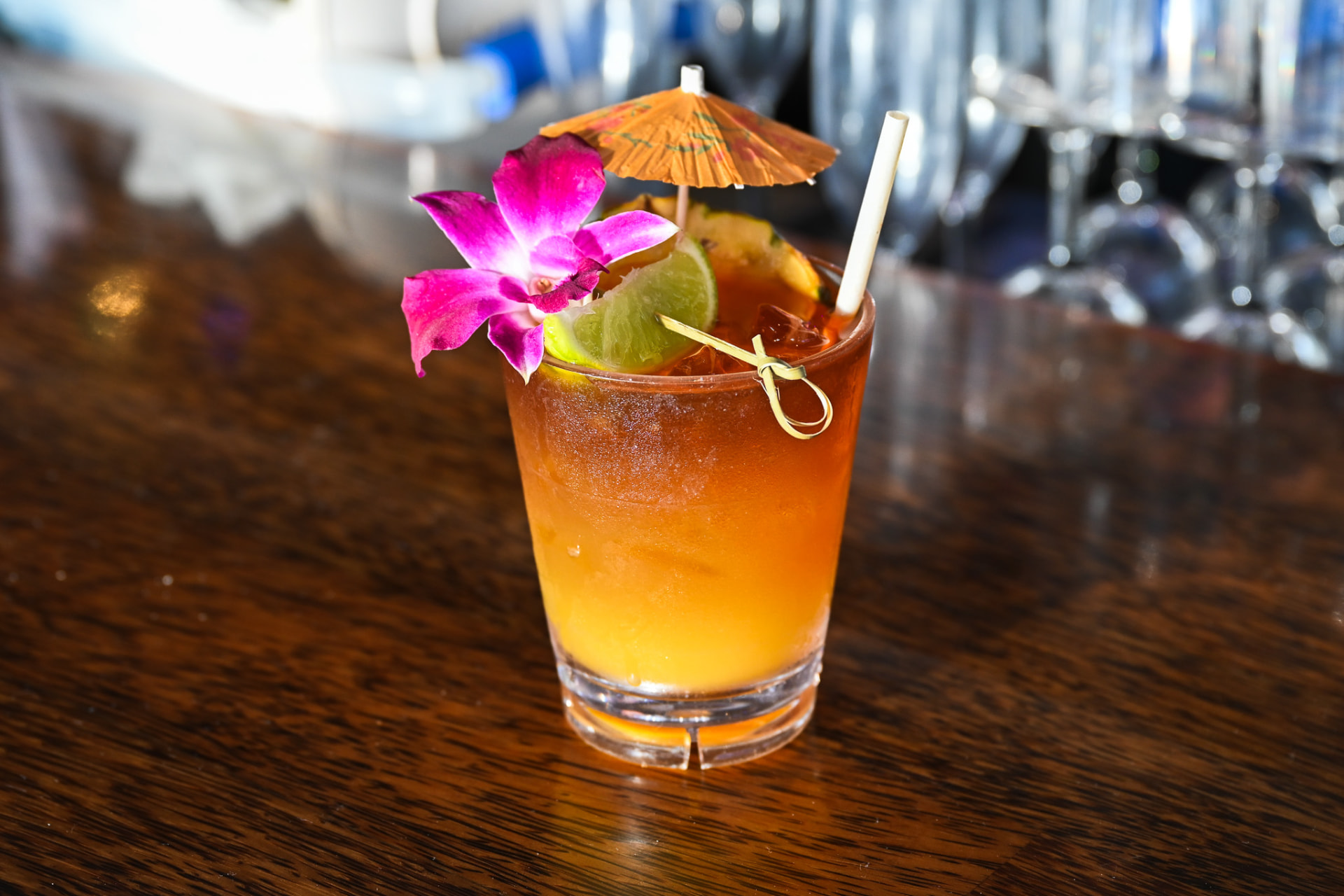 Mai tai with orchid and pineapple on the bar top